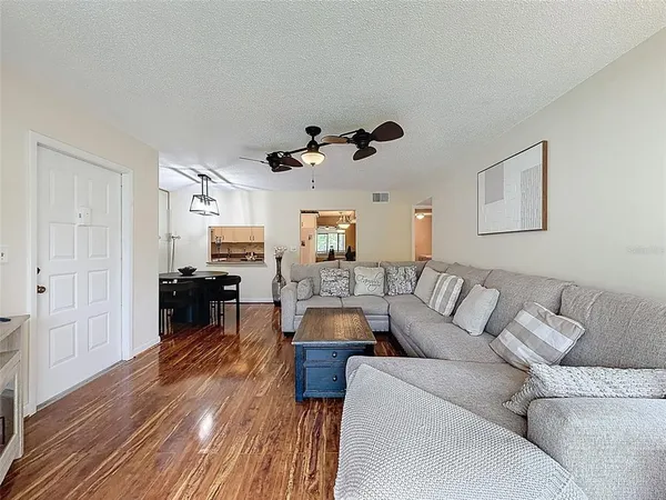 a view of a hallway to a livingroom with furniture