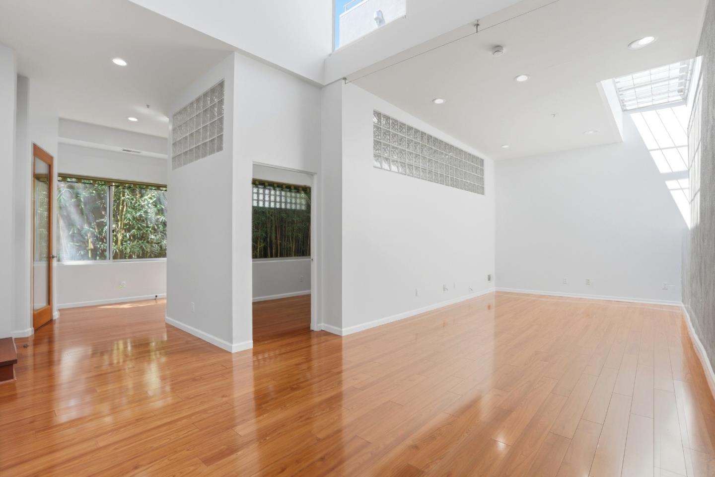 2709 Tenth Street, Unit C Berkeley, CA 94710 - Photo 11 of 44 an empty room with wooden floor and windows