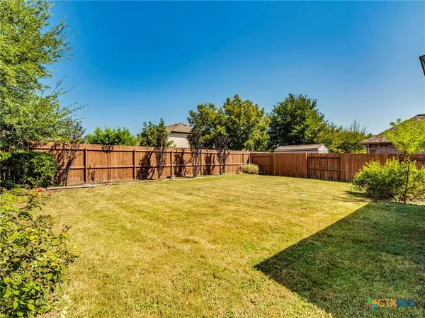 a view of a swimming pool with a yard