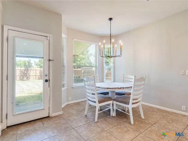 a view of a dining room with furniture wooden floor and chandelier