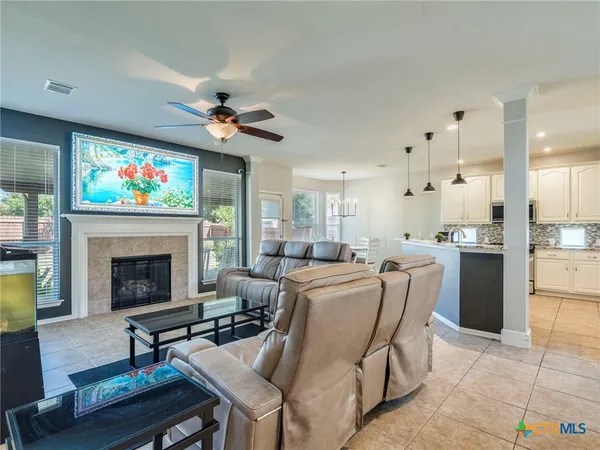 a living room with furniture a fireplace and a flat screen tv