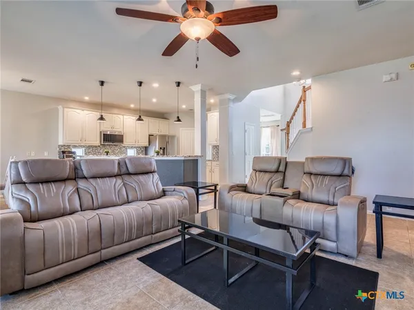 a living room with furniture and a chandelier