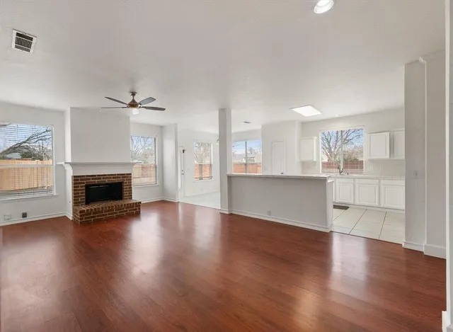 a large white kitchen with cabinets