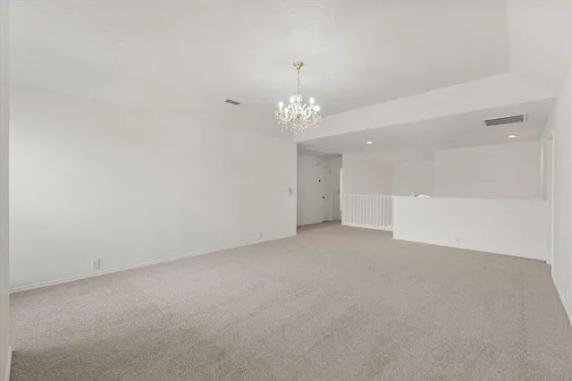 a view of a room with stairs and white walls