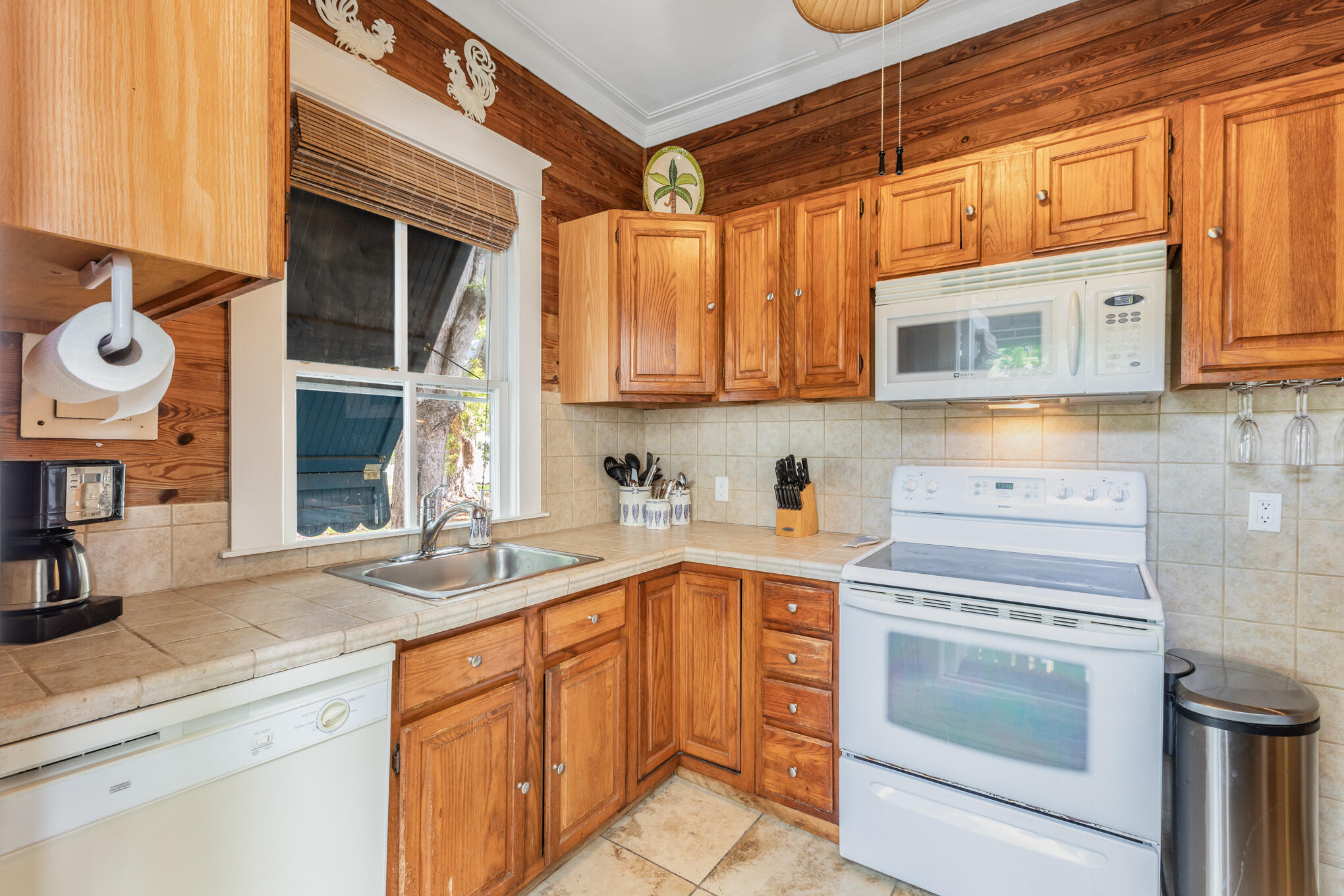 1203 Newton Street, Unit 1 Key West, FL 33040 - Photo 14 of 25 a kitchen with granite countertop a sink stove and cabinets