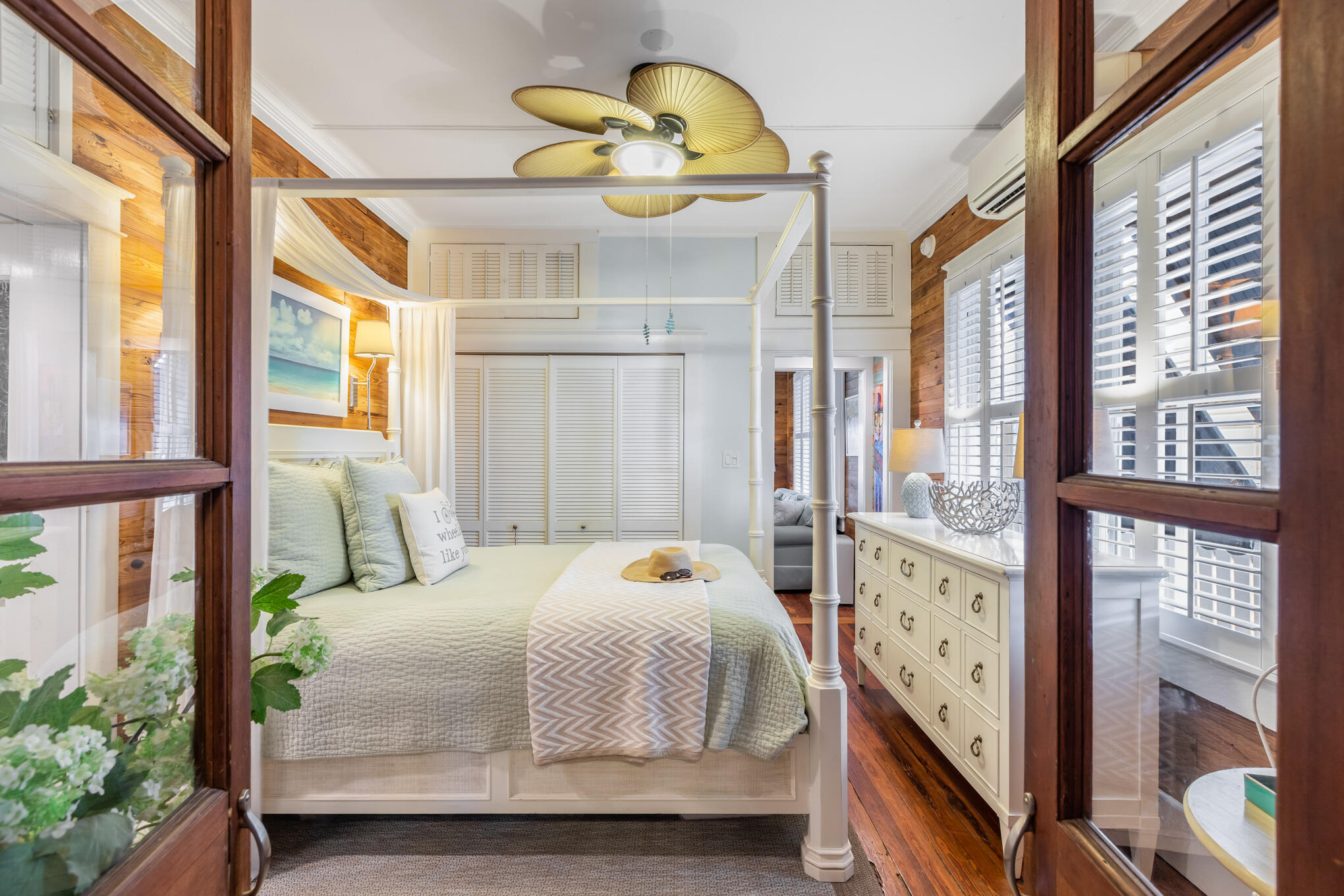 1203 Newton Street, Unit 1 Key West, FL 33040 - Photo 20 of 25 a bedroom with a bed and wooden floor