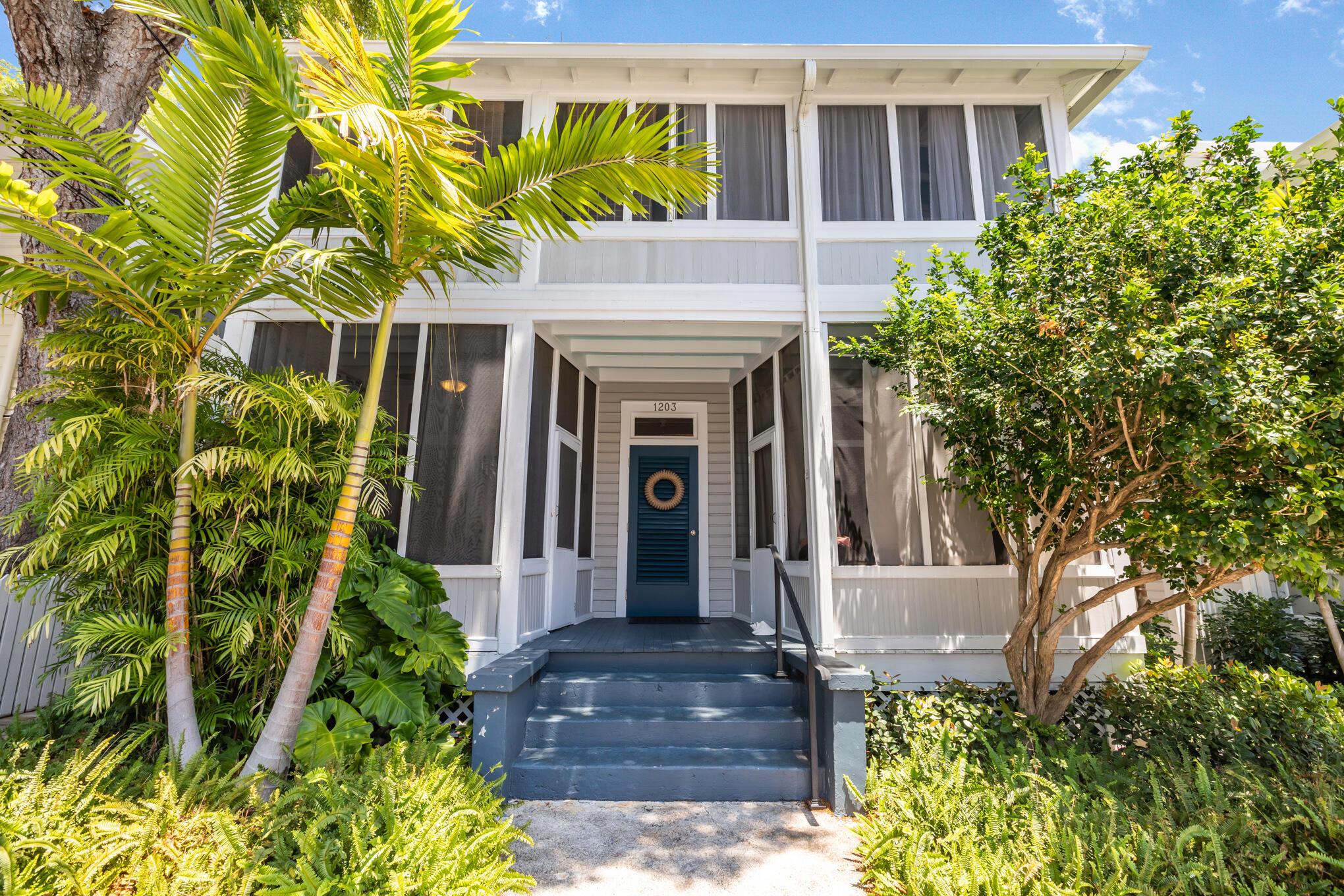1203 Newton Street, Unit 1 Key West, FL 33040 - Photo 2 of 25 a front view of a house with a garden