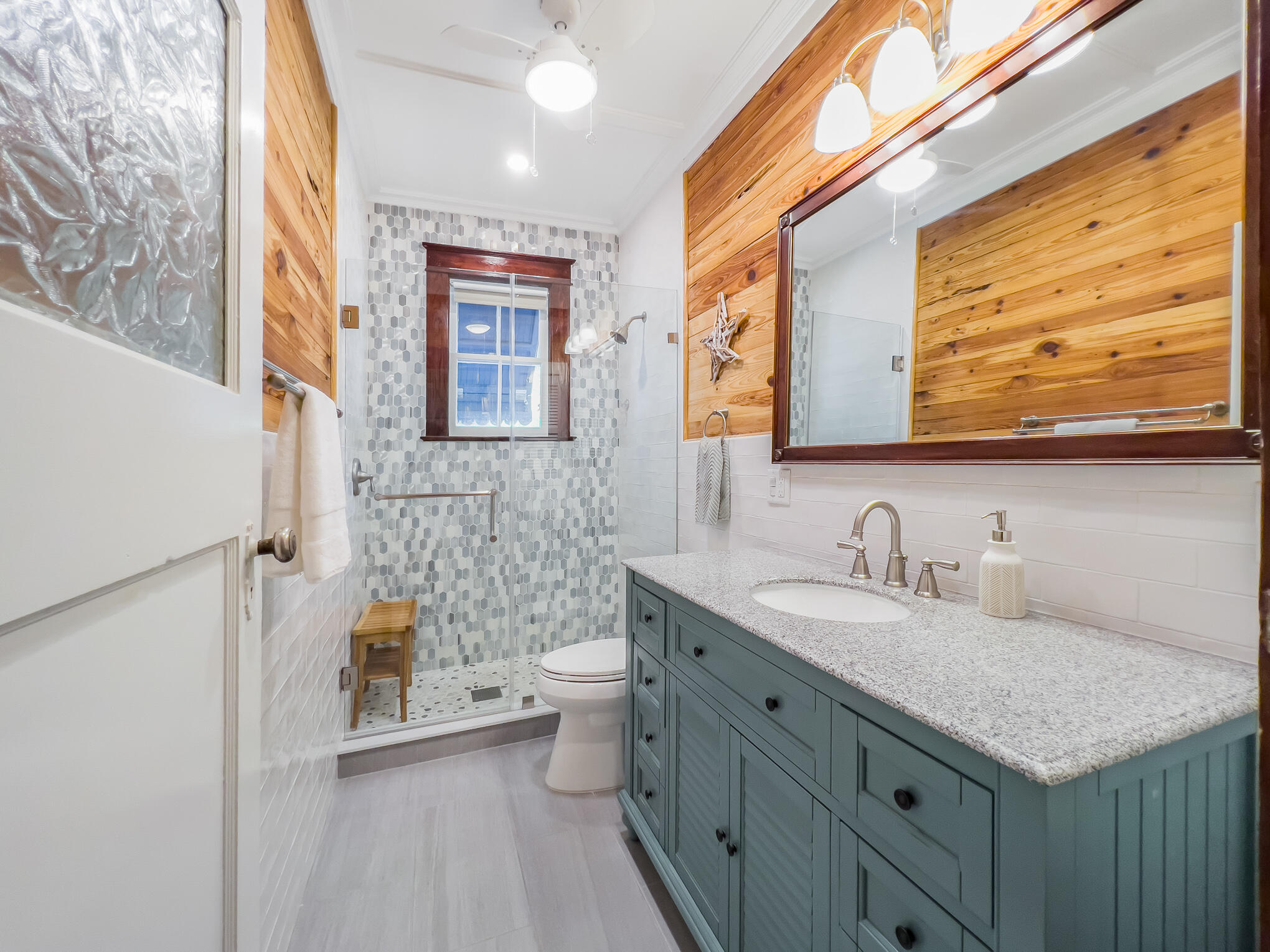 1203 Newton Street, Unit 1 Key West, FL 33040 - Photo 21 of 25 a bathroom with a granite countertop sink mirror vanity and toilet