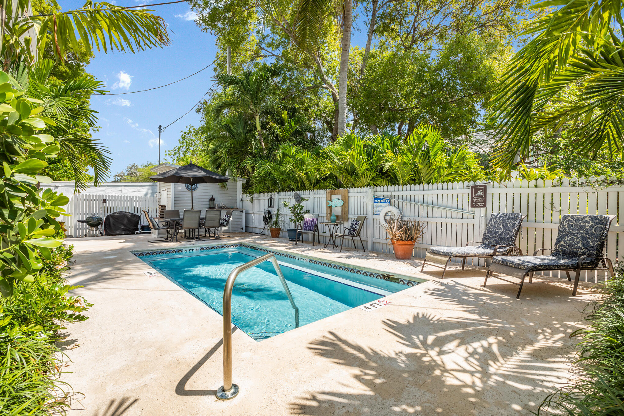 1203 Newton Street, Unit 1 Key West, FL 33040 - Photo 23 of 25 a view of swimming pool with chairs