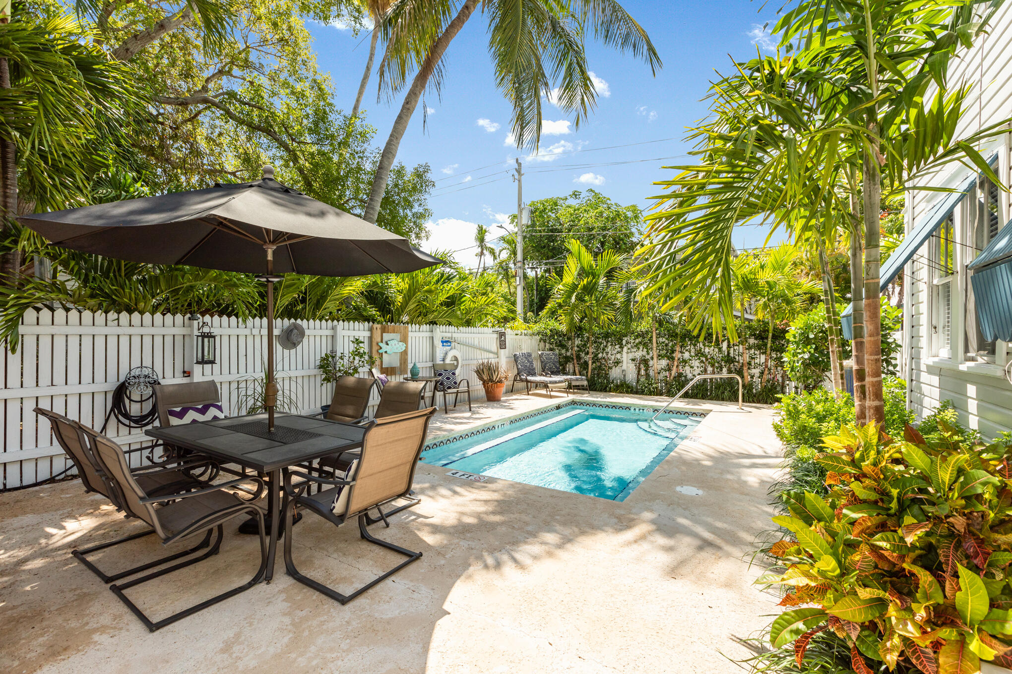 1203 Newton Street, Unit 1 Key West, FL 33040 - Photo 24 of 25 a view of backyard with outdoor seating and trees