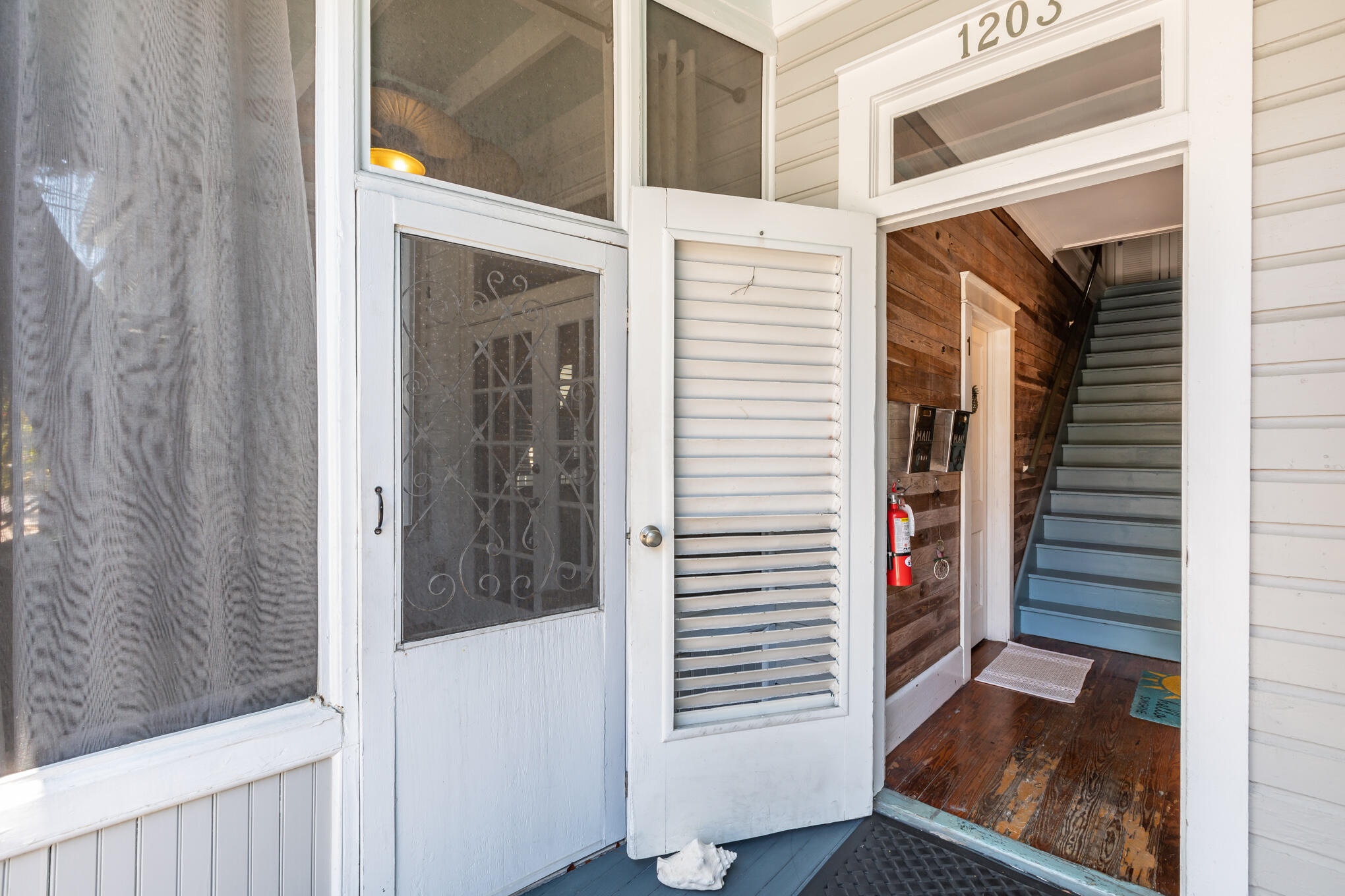 1203 Newton Street, Unit 1 Key West, FL 33040 - Photo 6 of 25 a view of a hallway with wooden floor and entryway