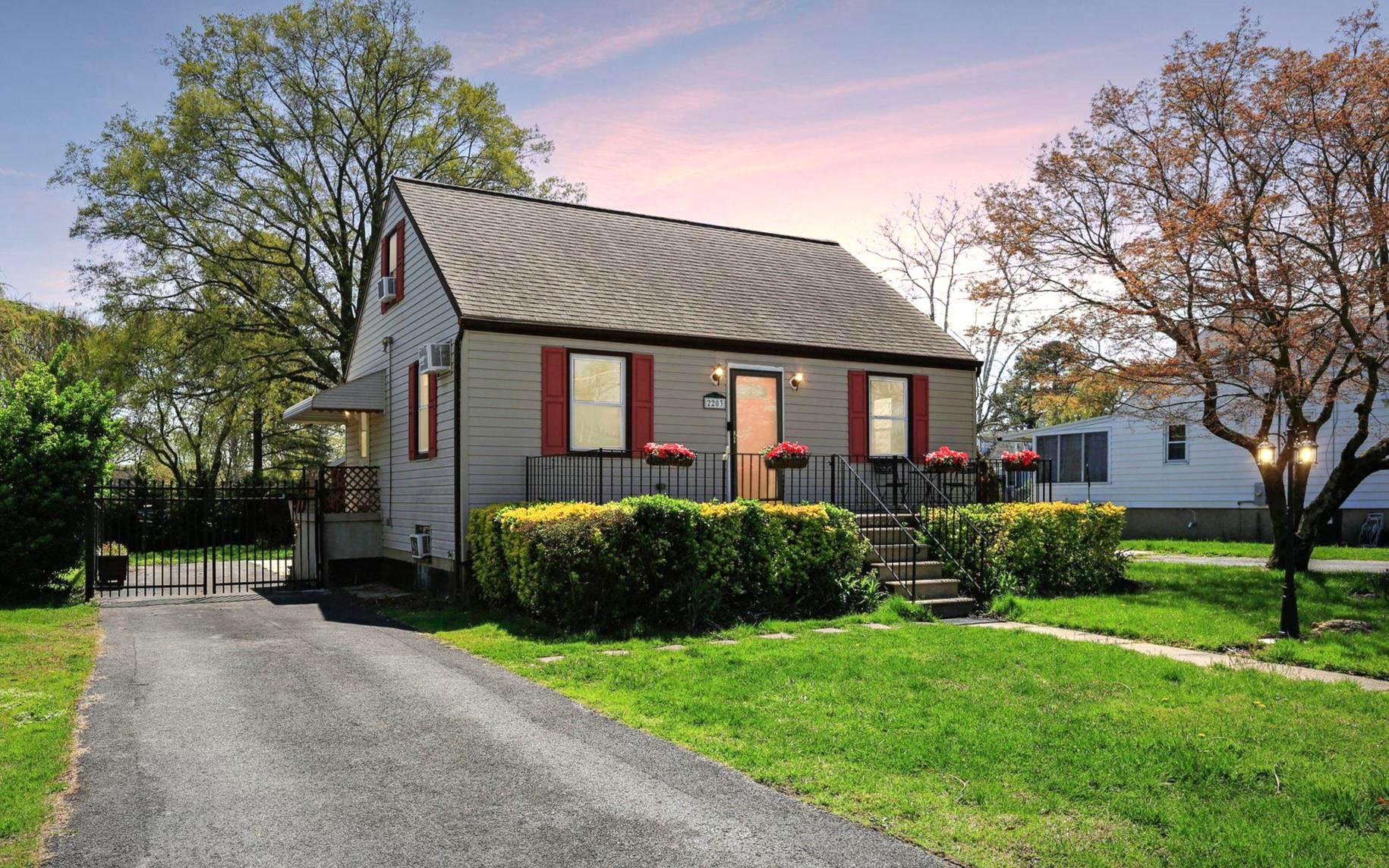 Charming home with lush green setting.