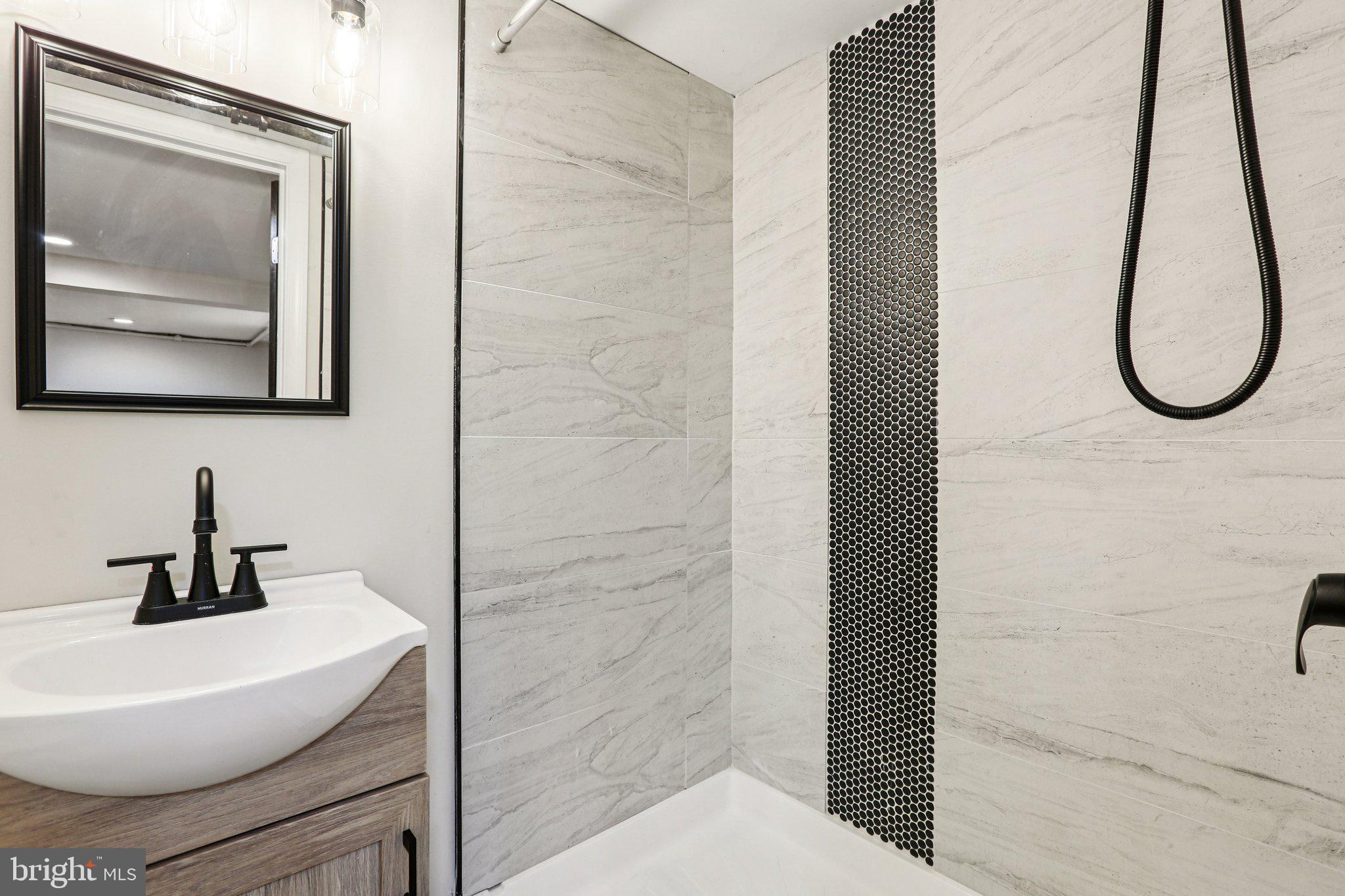 2203 Middleborough Road Essex, MD 21221 - Photo 32 of 35 Sleek modern bathroom with elegant tiles.