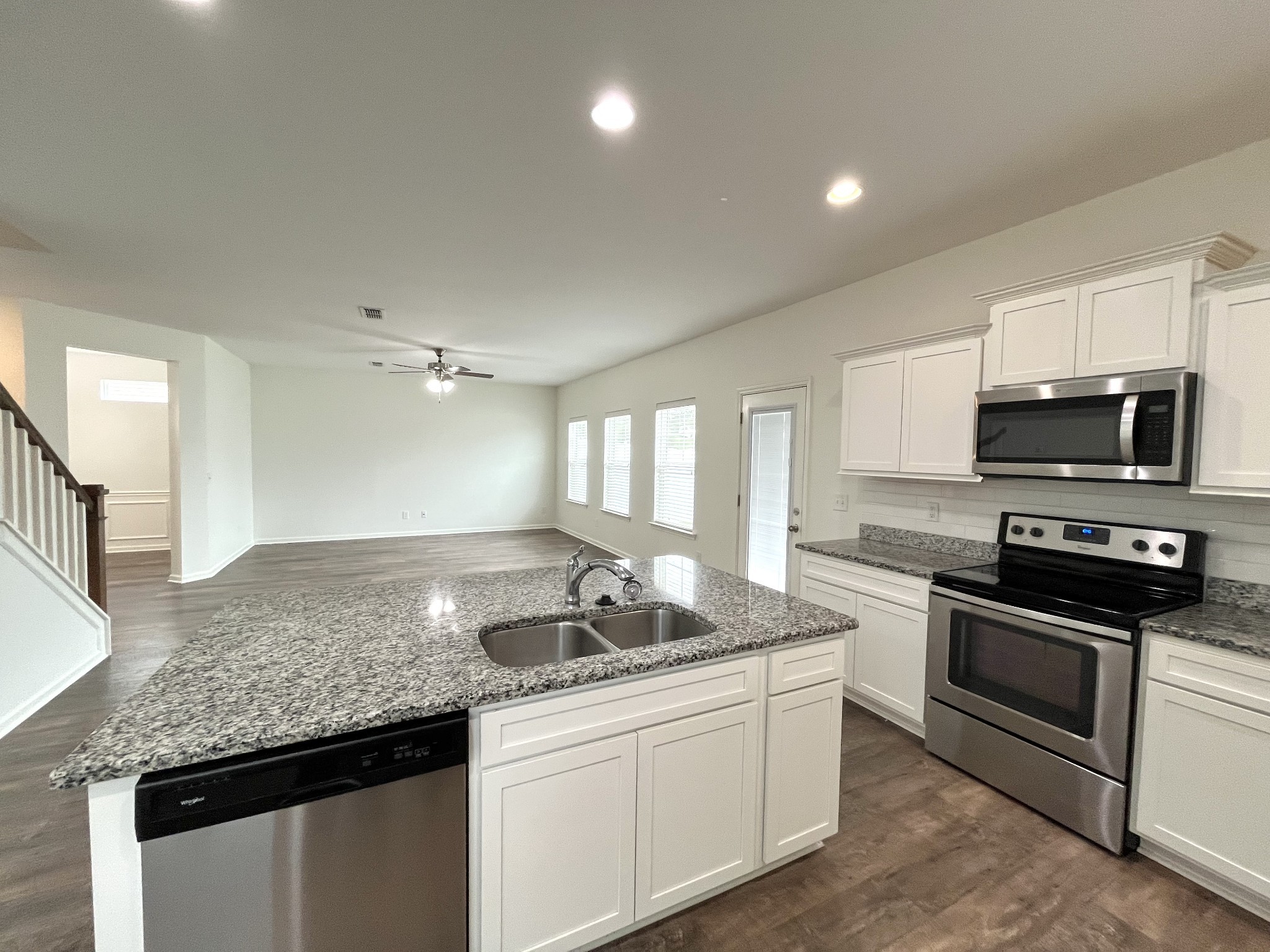 105 East Coker Way Spring Hill, TN 37174 - Photo 11 of 23 a kitchen with granite countertop stainless steel appliances a stove sink and microwave