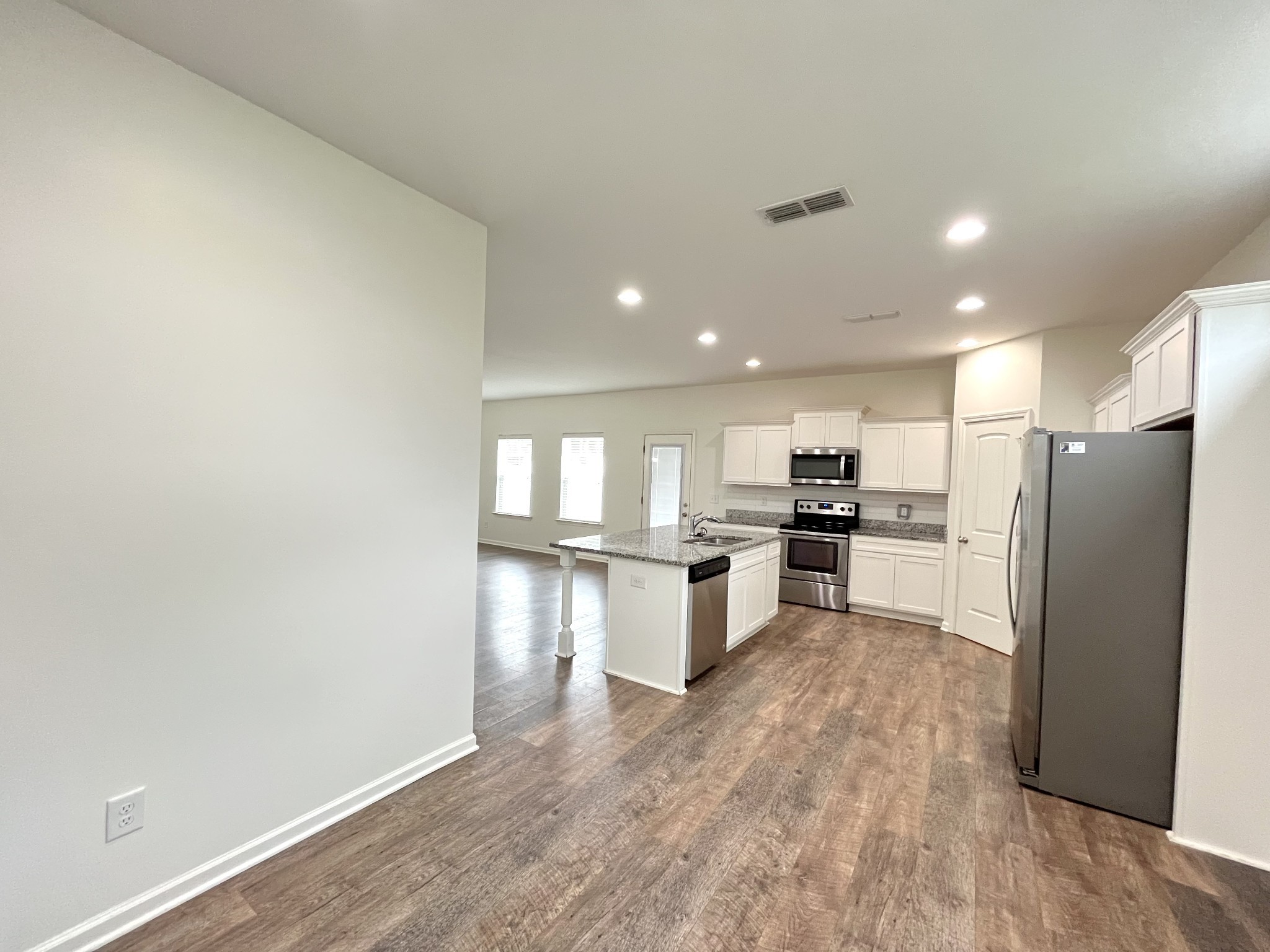105 East Coker Way Spring Hill, TN 37174 - Photo 14 of 23 a kitchen with a refrigerator and a sink