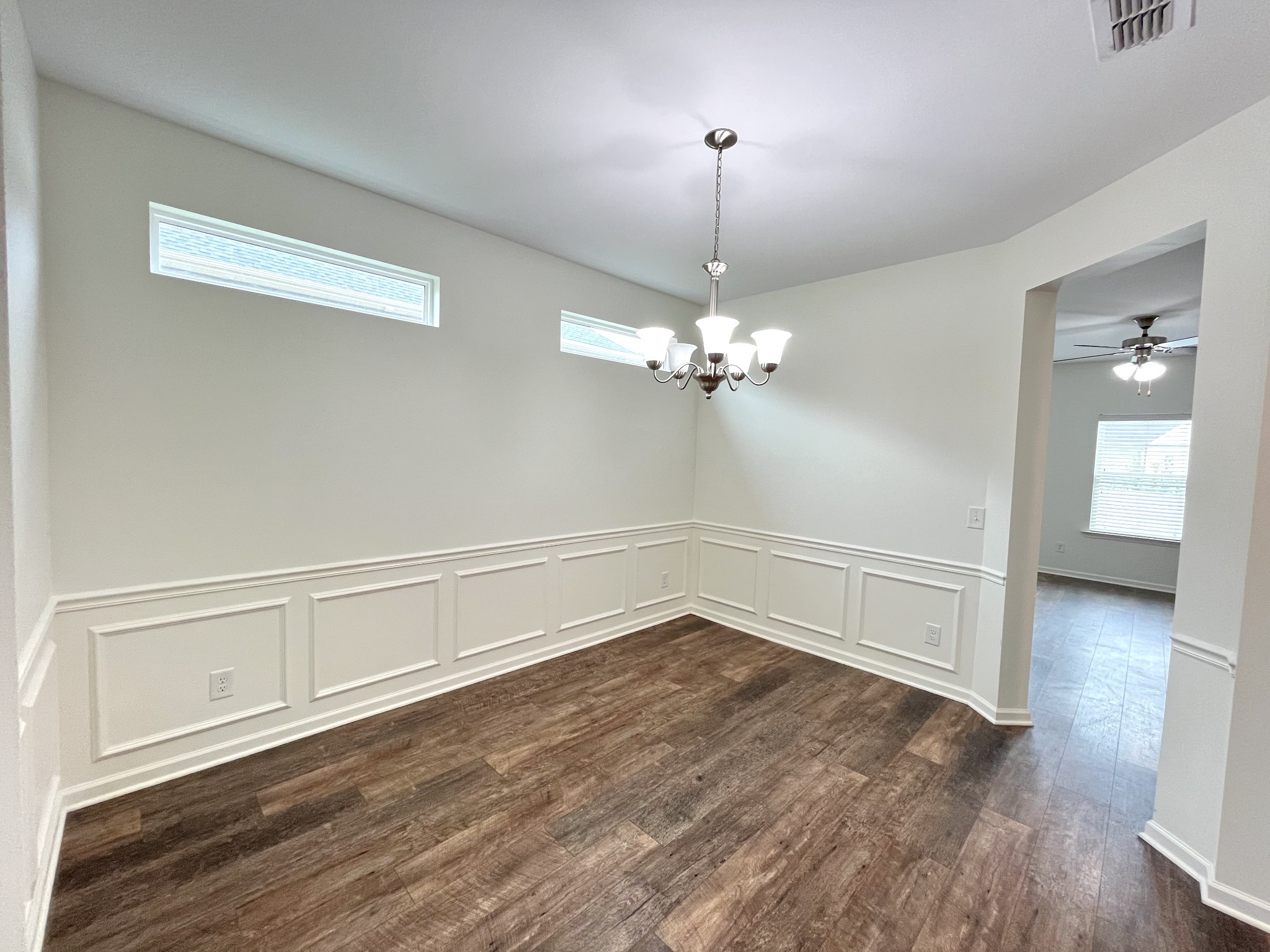 105 East Coker Way Spring Hill, TN 37174 - Photo 4 of 23 a view of an empty room with wooden floor and a window