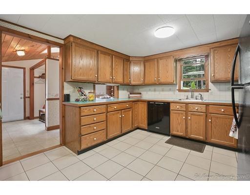 6 Newbury Road Rowley, MA 01969 - Photo 3 of 19 a kitchen with a stove a sink and a refrigerator