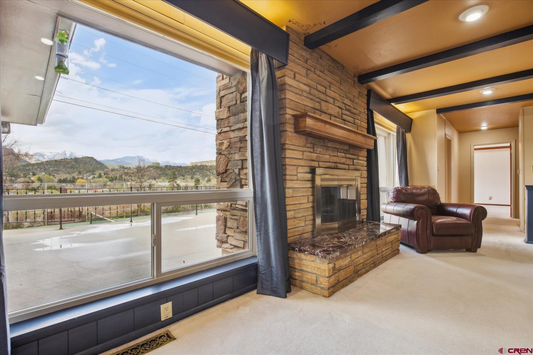 151 Riverview Drive Durango, CO 81301 - Photo 12 of 45 a view of a balcony with furniture and a floor to ceiling window