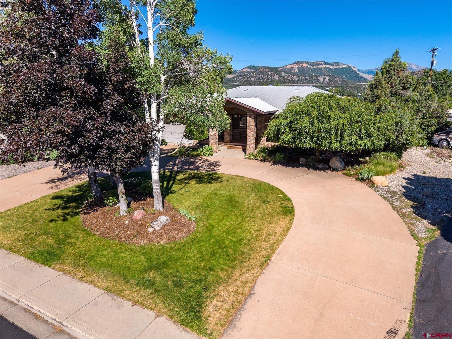 151 Riverview Drive Durango, CO 81301 - Photo 2 of 45 a view of a backyard with a garden and plants