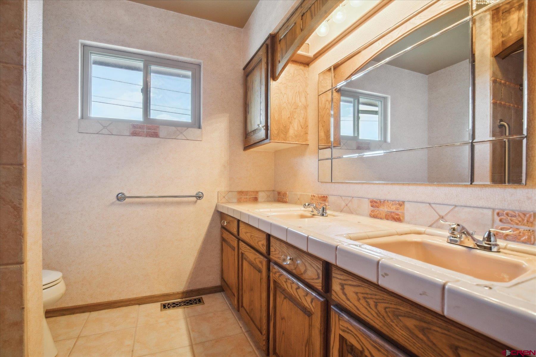 151 Riverview Drive Durango, CO 81301 - Photo 25 of 45 a bathroom with a sink and a mirror