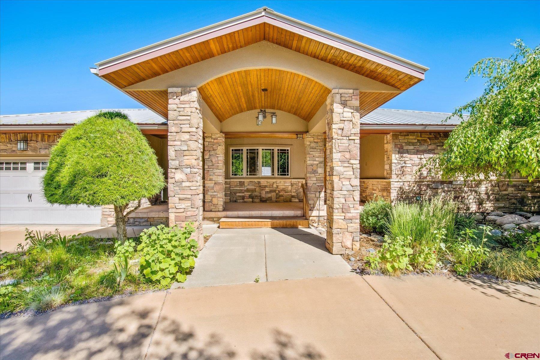 151 Riverview Drive Durango, CO 81301 - Photo 10 of 45 a front view of a house with garden
