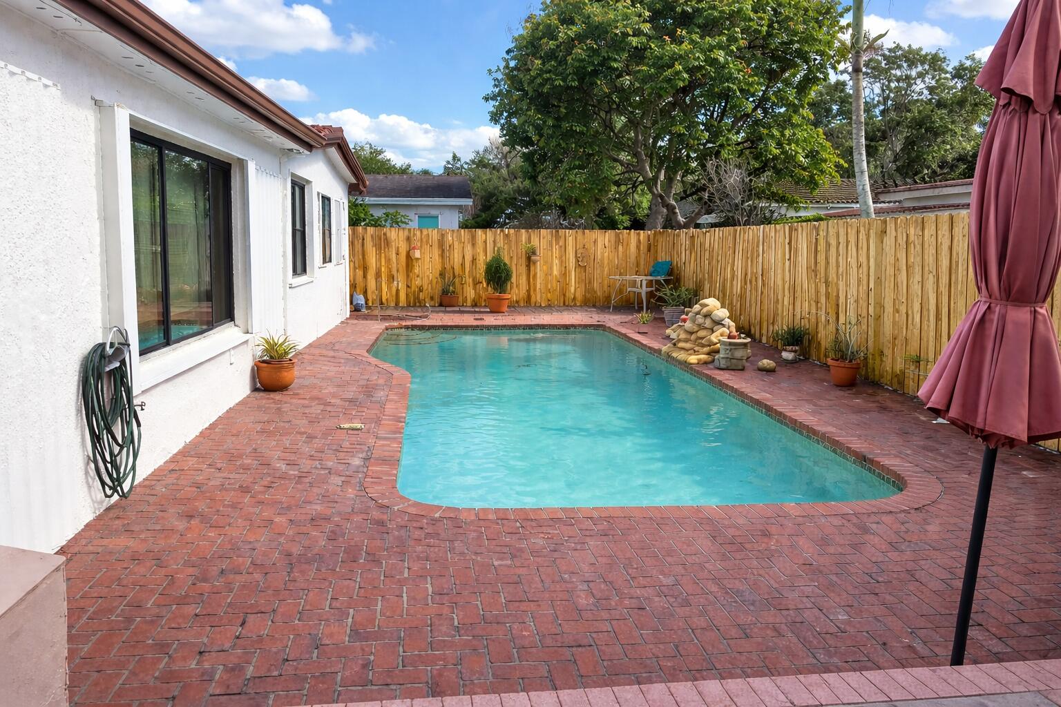10478 Northwest 4th Street Plantation, FL 33324 - Photo 2 of 3 a view of a backyard with lawn chairs wooden floor and fence