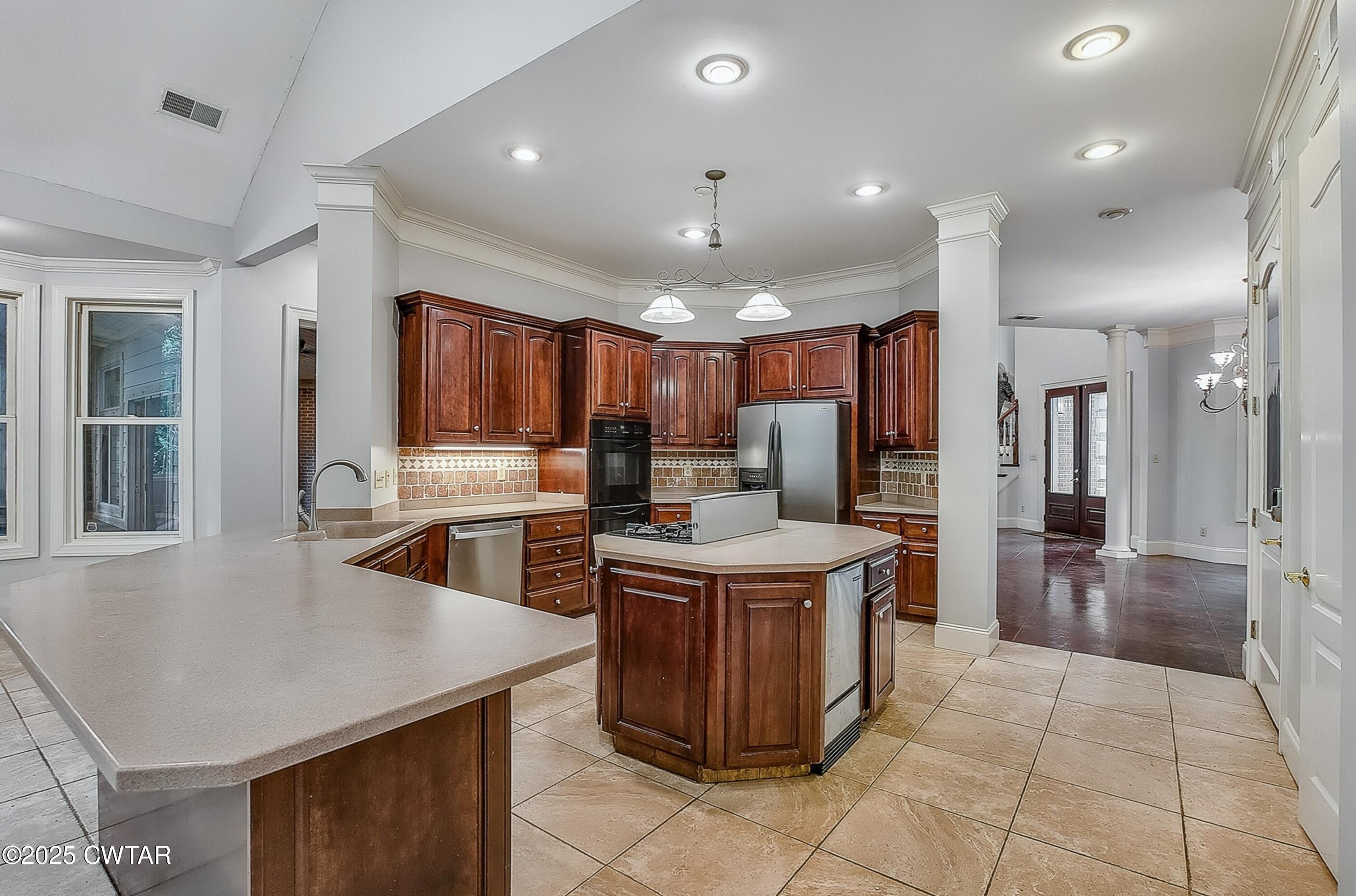 26 Bridlepath Drive Jackson, TN 38305 - Photo 15 of 53 a kitchen with stainless steel appliances granite countertop a stove oven and a refrigerator