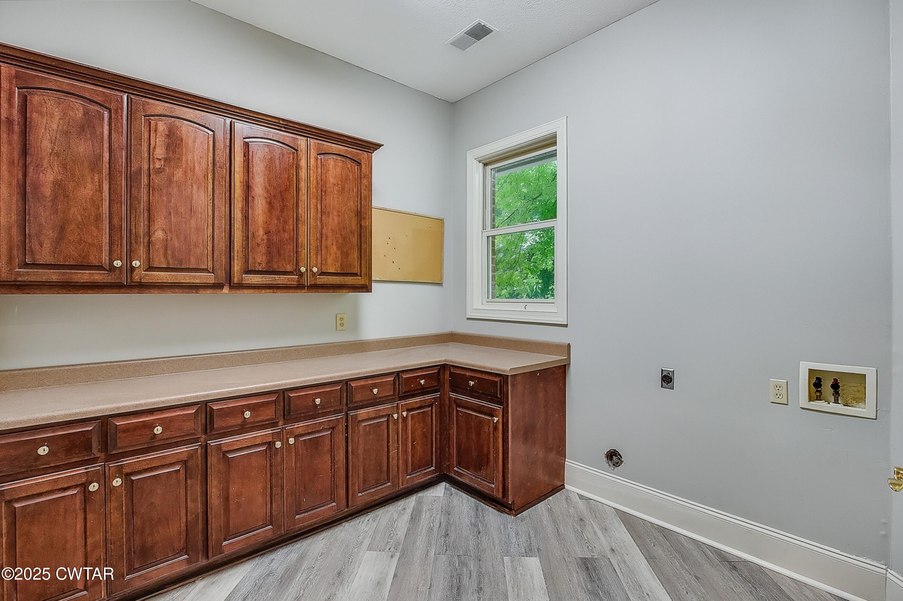 26 Bridlepath Drive Jackson, TN 38305 - Photo 25 of 53 a kitchen with stainless steel appliances granite countertop a sink a stove cabinets and wooden floor
