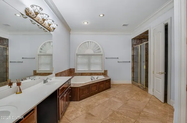 a bathroom with a tub and a shower