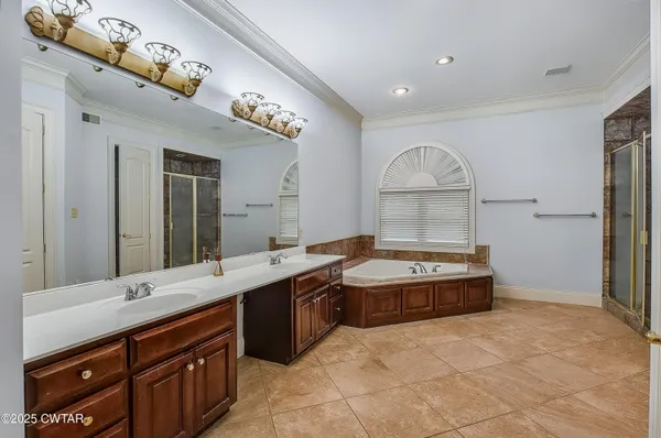 a view of a hallway with wooden floor and a ceiling fan