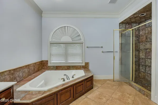 a view of a utility room with wooden floor and a ceiling fan