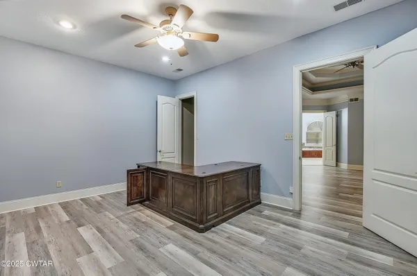 a bedroom with a bed and a ceiling fan
