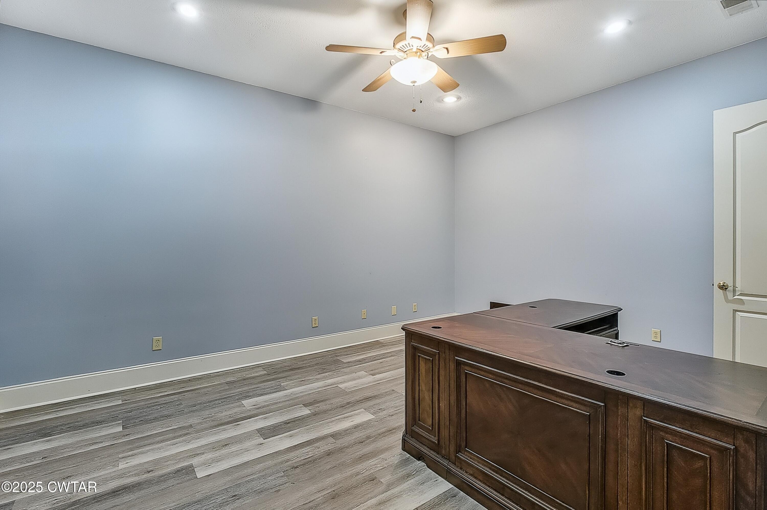 26 Bridlepath Drive Jackson, TN 38305 - Photo 33 of 53 a view of a utility room with wooden floor and a ceiling fan