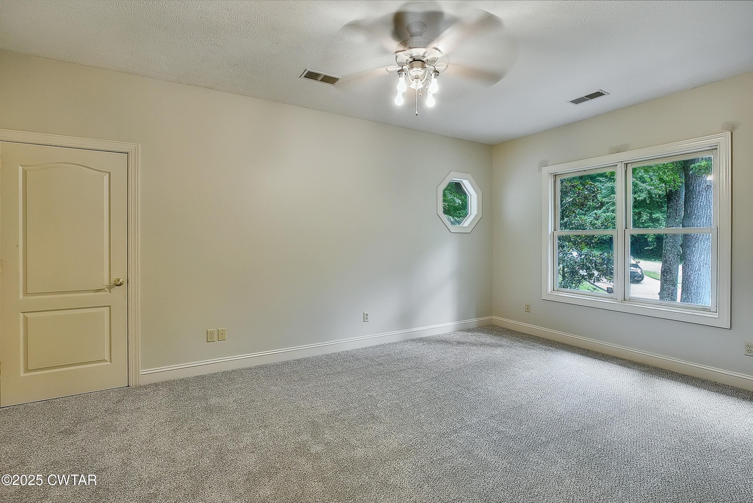 26 Bridlepath Drive Jackson, TN 38305 - Photo 35 of 53 an empty room with windows and fan