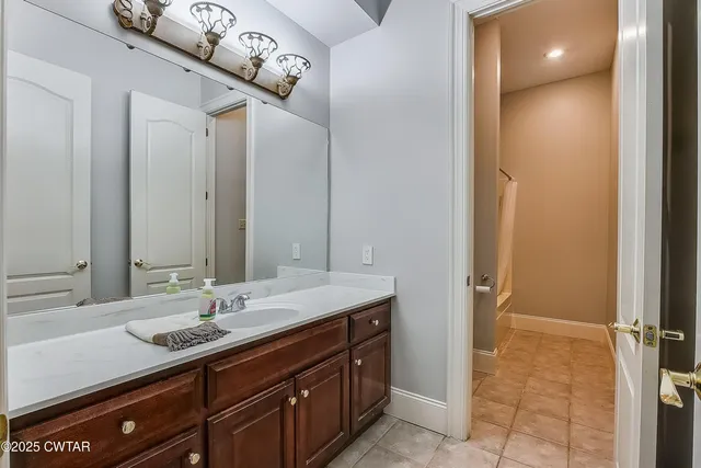 an empty room with a window and a ceiling fan