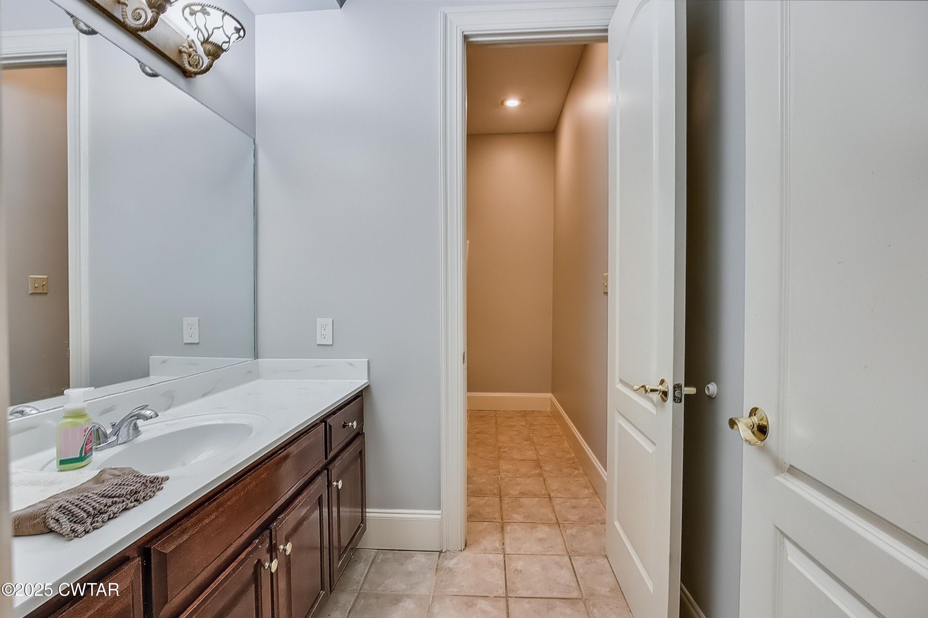26 Bridlepath Drive Jackson, TN 38305 - Photo 39 of 53 a bathroom with a granite countertop sink a mirror and a shower