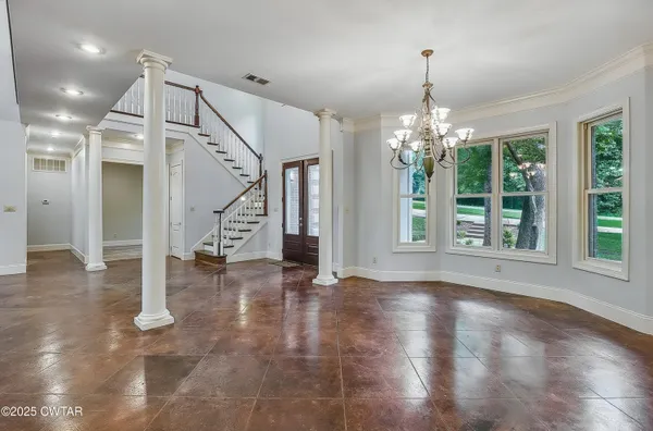 a view of an entryway with wooden floor and a chandelier