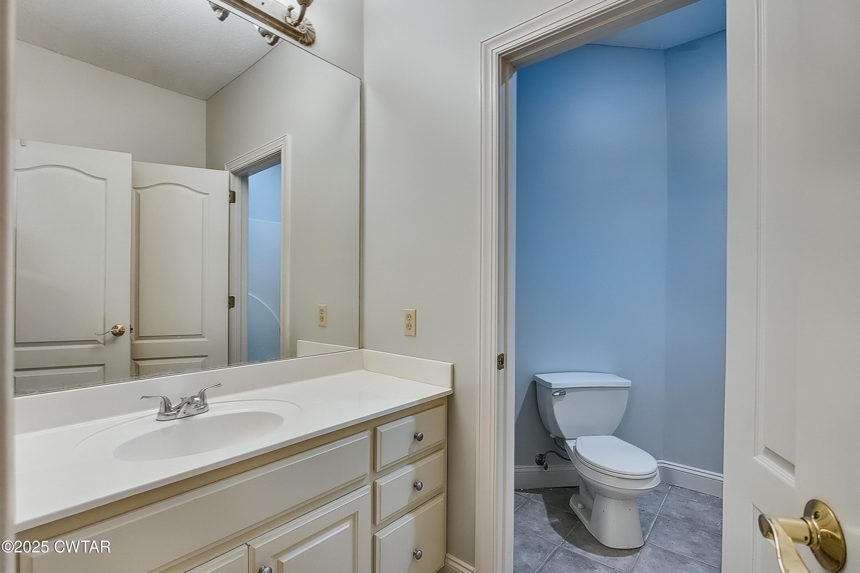 26 Bridlepath Drive Jackson, TN 38305 - Photo 45 of 53 a bathroom with a toilet a sink and mirror
