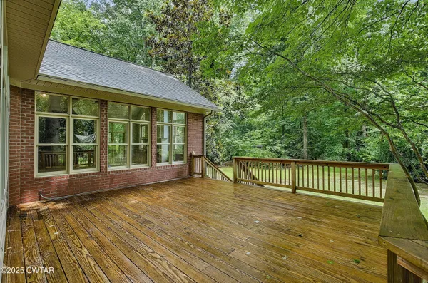 a view of a balcony with chairs and wooden floor