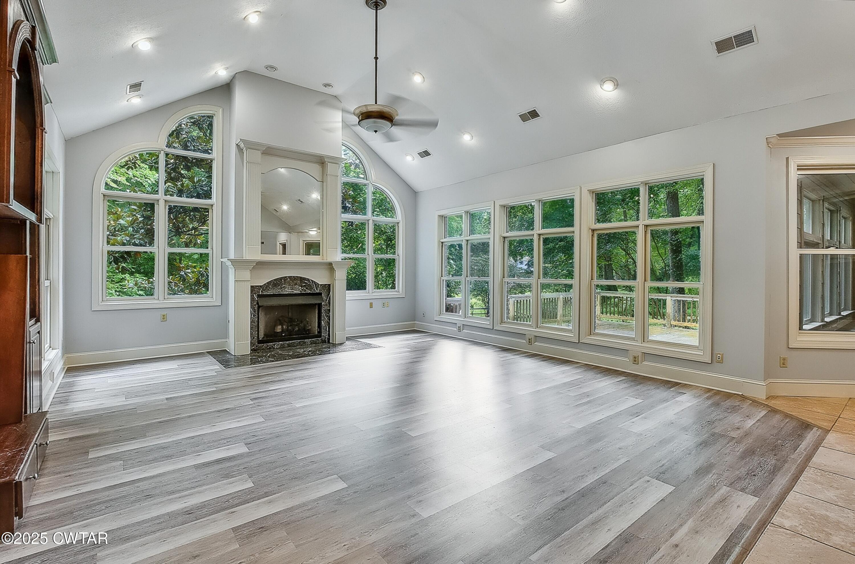 26 Bridlepath Drive Jackson, TN 38305 - Photo 9 of 53 an empty room with fireplace large windows and wooden floor