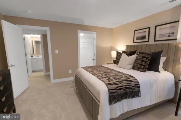 a bedroom with a bed and painting on the wall