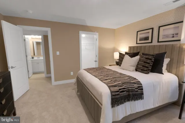 a bedroom with a bed and painting on the wall