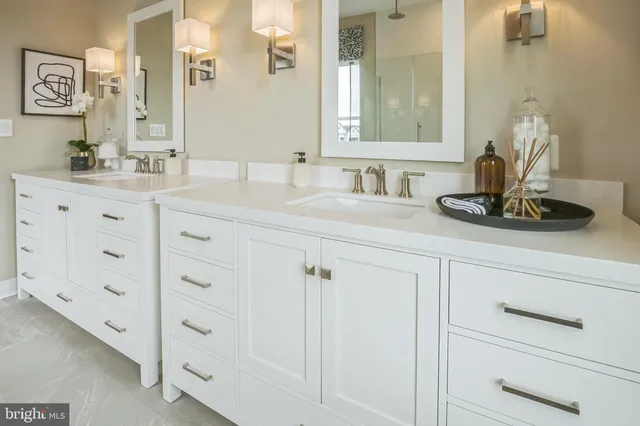 a bathroom with cabinets appliances and a mirror