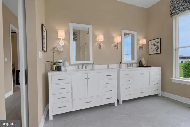 a bathroom with double vanity sink a mirror a window and vanity