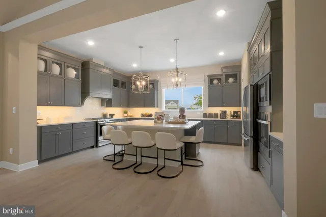 a large kitchen with a table and chairs