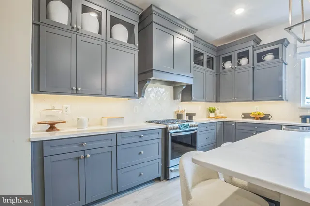a kitchen with cabinets appliances and a sink