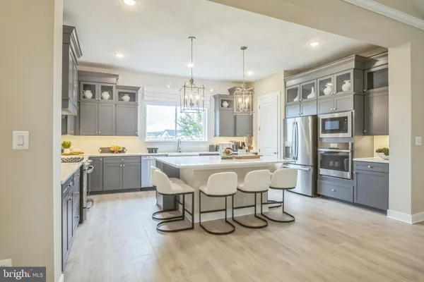 a large kitchen with a table and chairs