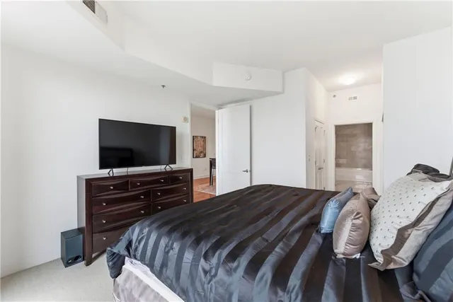 a bedroom with a bed and a flat screen tv