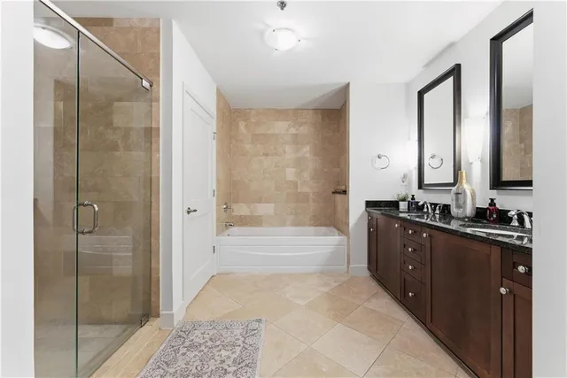 a large bathroom with a glass shower door a sink and a mirror