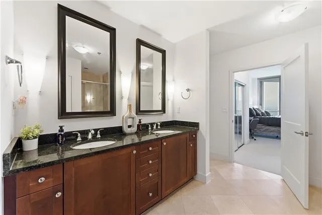 a en suite bathroom with double sink and a mirror